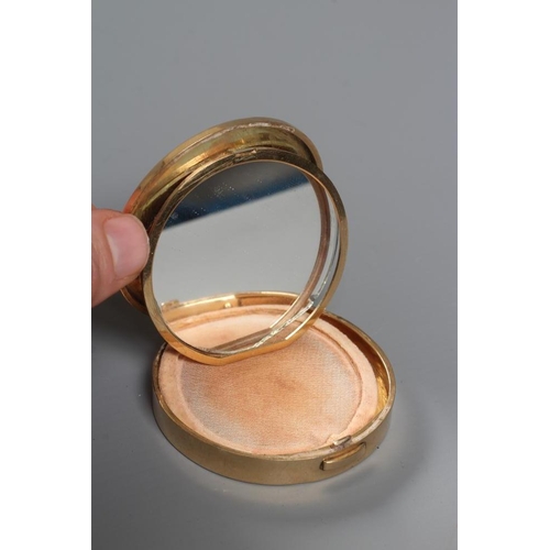 115 - A CARTIER ART DECO 9CT GOLD CIRCULAR COMPACT, London 1945, the concentric circle engine turned cover... 