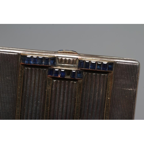 116 - AN ART DECO SILVER COMPACT imported by Stockwell & Co., London 1935, of square form with engine turn... 