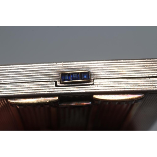 116 - AN ART DECO SILVER COMPACT imported by Stockwell & Co., London 1935, of square form with engine turn... 