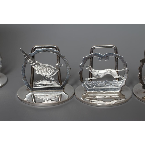 120 - A COMPOSITE SET OF EIGHT SILVER NOVELTY MENU/PLACE CARD HOLDERS, four by A. Wilcox, Chester 1932, pi... 