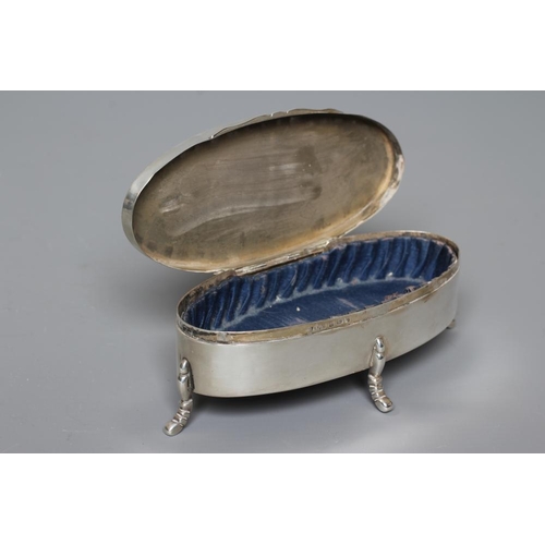 134 - A SILVER OVAL DRESSING TABLE BOX by Hasset & Harper Ltd., Birmingham 1918, the cover bright cut engr... 