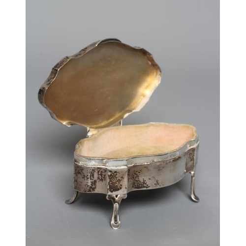 136 - A SILVER DRESSING TABLE BOX by S Blanckensee & Son Ltd., Birmingham 1926, of shaped oval form, the h... 