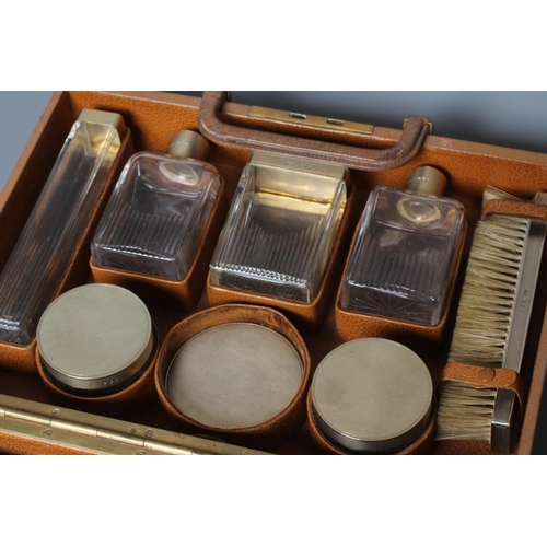 184 - AN ART DECO ELEVEN PIECE SILVER TRAVELLING DRESSING SET, maker's mark B & GH, Birmingham 1941, compr... 