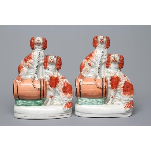 20 - A COLLECTION OF VICTORIAN POTTERY SPANIELS comprising a pair of spaniels with a barrel, 8