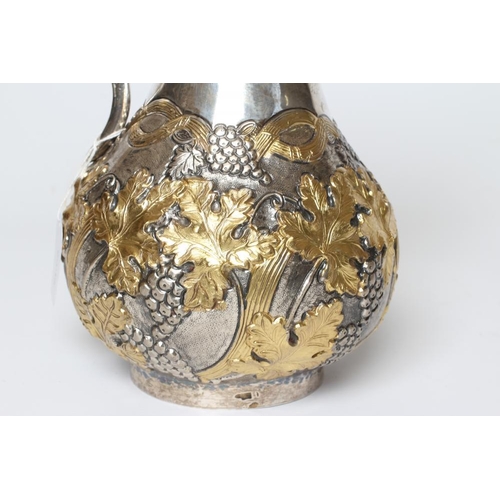 201 - A SILVER WINE EWER, stamped 900 YM(?), of baluster form with S scroll hollow handle, the partial par... 