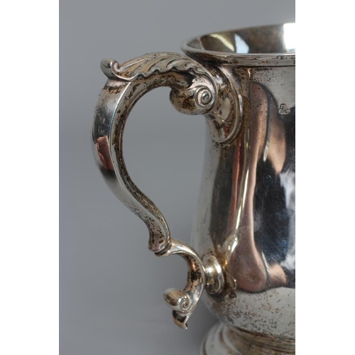 210 - AN EDWARDIAN SILVER MUG by Wakely & Wheeler, London 1904, of baluster form with acanthus leaf sheath... 