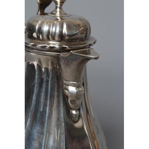 214 - AN EDWARDIAN SILVER HOT MILK JUG by Lambert & Co., London 1903, of lobed baluster form, the hinged d... 