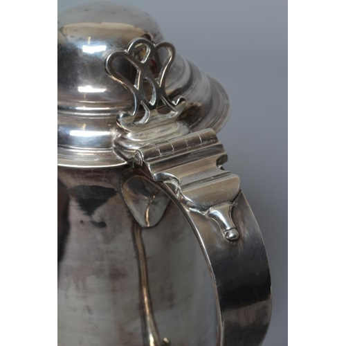 216 - A GEORGE III TANKARD by John Denzilow, London 1776, of tapering cylindrical form on a spreading foot... 