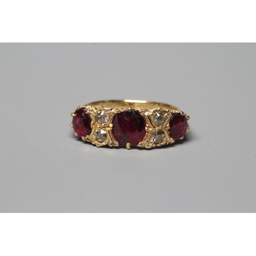 288 - A LATE VICTORIAN THREE STONE RUBY RING, the graduated circular facet cut stones claw set with four r... 