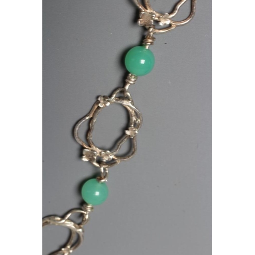 295 - ANNO DOMINI - an Ann O'Donnell silver wirework necklace, the thirteen panels with twelve green bead ... 