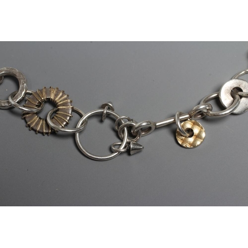 299 - A SILVER NECKLACE BY ADELE TAYLOR, the plain circular links hung with cast 'found' objects, Sheffiel... 