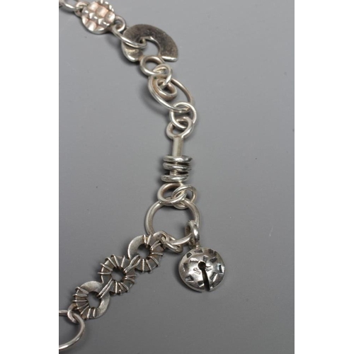 299 - A SILVER NECKLACE BY ADELE TAYLOR, the plain circular links hung with cast 'found' objects, Sheffiel... 