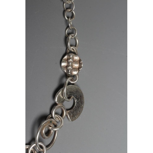 299 - A SILVER NECKLACE BY ADELE TAYLOR, the plain circular links hung with cast 'found' objects, Sheffiel... 