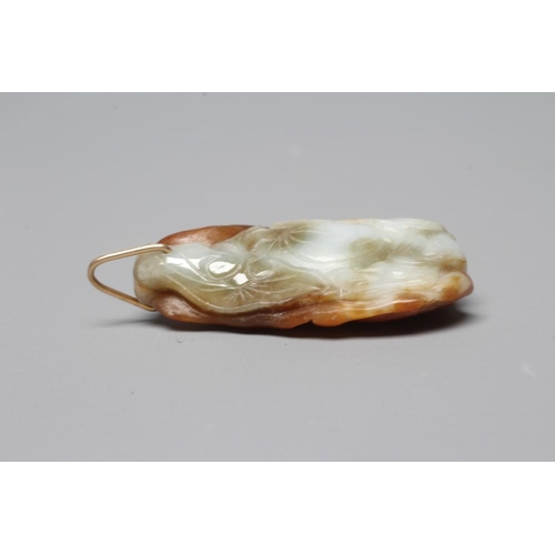 302 - A CHINESE JADE PENDANT, one side carved as a hare (?) beside a flower, the other with a persimmon, u... 