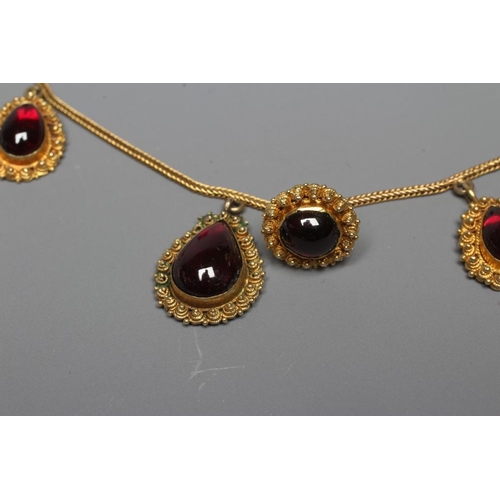 316 - A VICTORIAN GARNET NECKLACE, the five graduating tear shaped carbuncles close back set in the classi... 