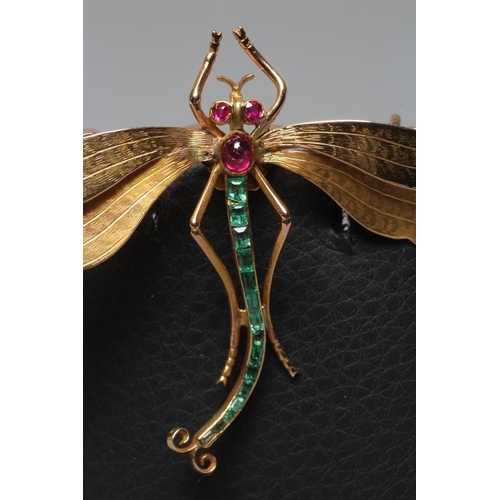 319 - A DRAGONFLY BROOCH with engraved wings, facet cut ruby eyes and cabochon thorax, and channel set gra... 