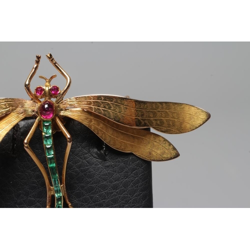 319 - A DRAGONFLY BROOCH with engraved wings, facet cut ruby eyes and cabochon thorax, and channel set gra... 