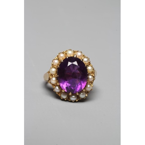 322 - AN AMETHYST AND SEED PEARL RING, the oval facet cut amethyst claw set to a border of fourteen seed p... 