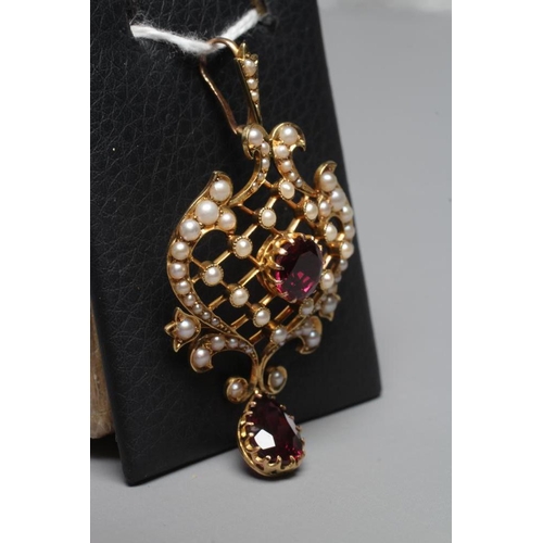 329 - AN EDWARDIAN GARNET AND SEED PEARL PENDANT of typical shield form with knife edge diapered centre, c... 