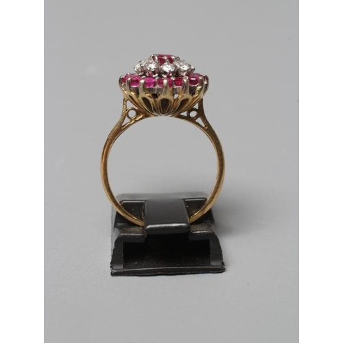 355 - A RUBY AND DIAMOND CLUSTER RING, the central ruby claw set to a border of eight small diamonds and a... 