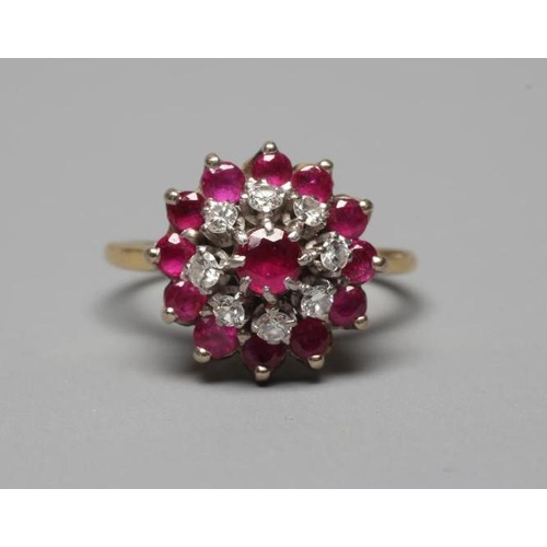 355 - A RUBY AND DIAMOND CLUSTER RING, the central ruby claw set to a border of eight small diamonds and a... 