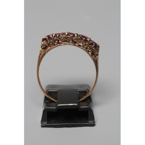 359 - A FIVE STONE GARNET RING, the graduating oval facet cut stones in a bark mount on a plain 9ct gold s... 