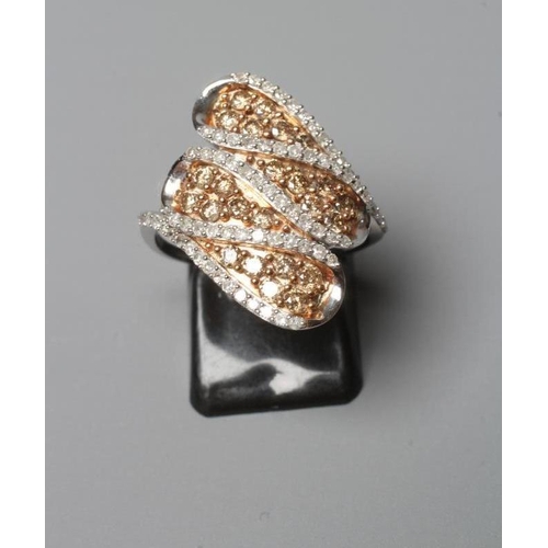 377 - A DIAMOND COCKTAIL RING, the four coma shaped panels centred by small champagne coloured stones to a... 