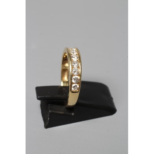 379 - A TEN STONE DIAMOND HALF HOOP ETERNITY RING, the brilliant cut stones channel set to a plain shank s... 