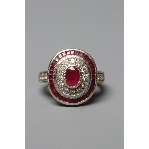 380 - A RUBY AND DIAMOND TARGET PLAQUE RING, the oval cut ruby of approximately 1ct collet set to a border... 