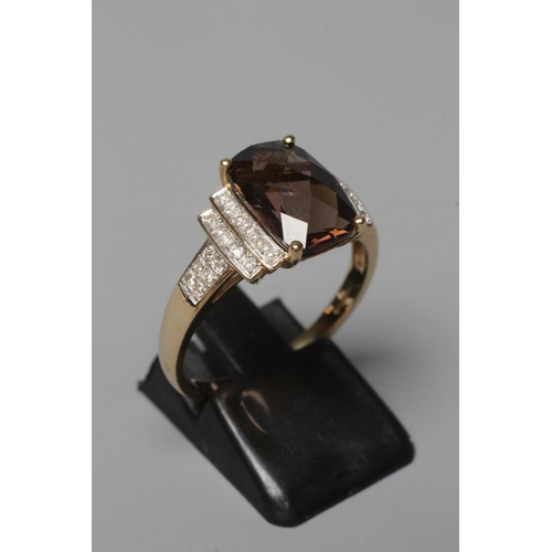 381 - A DRESS RING, the oblong facet cut smoky quartz claw set to stepped shoulders point set with numerou... 