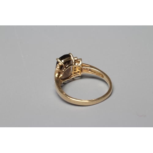 381 - A DRESS RING, the oblong facet cut smoky quartz claw set to stepped shoulders point set with numerou... 