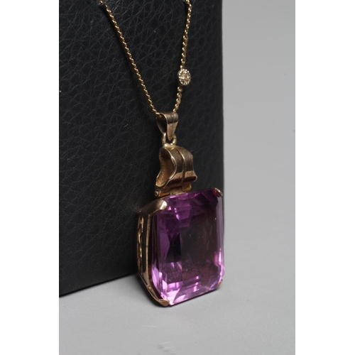 383 - AN AMETHYST PENDANT, the oblong facet cut stone claw set to a plain unmarked frame with hinged bale,... 