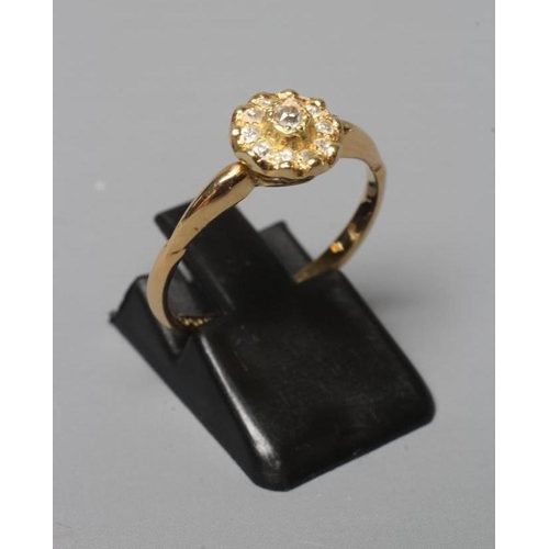 385 - AN EDWARDIAN DIAMOND CLUSTER RING, the ten mix cut stones in rub over setting to a plain 18ct gold s... 