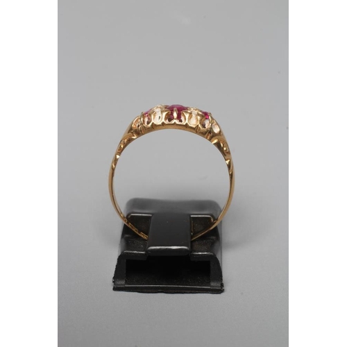 387 - AN EDWARDIAN RUBY AND DIAMOND RING, the three graduated rubies with four diamond points between to c... 