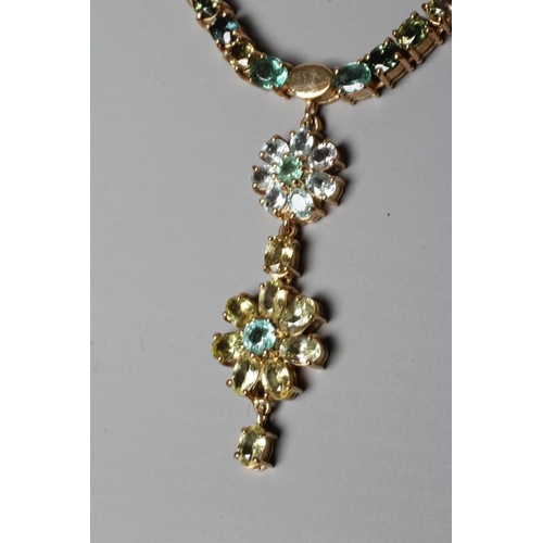 391 - A TOURMALINE FLOWERHEAD NECKLACE, the two mixed colour graduated flowerhead pendants hanging from a ... 