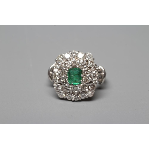 392 - AN EMERALD AND DIAMOND CLUSTER COCKTAIL RING, the central oval facet cut emerald claw set to a doubl... 