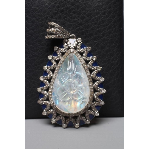 393 - A MOONSTONE AND DIAMOND PENDANT, the pear cut moonstone carved with a flowerhead and claw set to an ... 