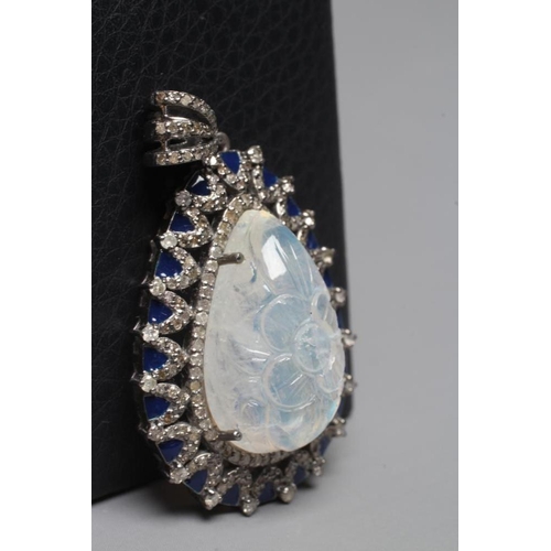 393 - A MOONSTONE AND DIAMOND PENDANT, the pear cut moonstone carved with a flowerhead and claw set to an ... 