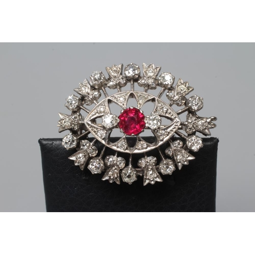 396 - A RUBY AND DIAMOND BROOCH, the central circular facet cut ruby claw set to open borders of old mix c... 