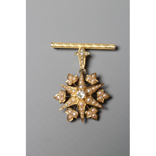 398 - A DIAMOND AND SEED PEARL STAR PENDANT, the central old brilliant cut stone of approximately 0.30cts,... 