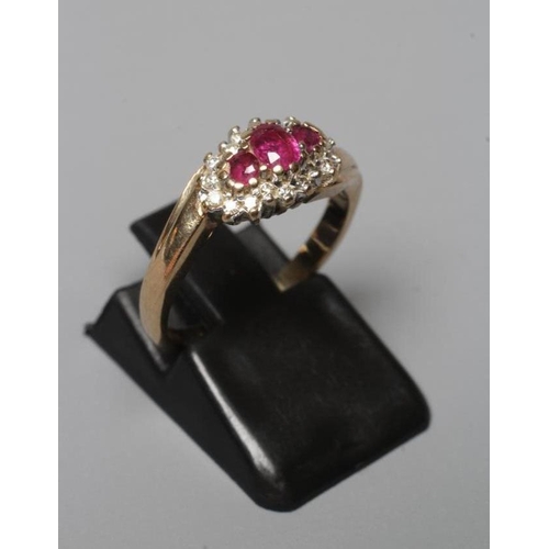 401 - A RUBY AND DIAMOND CROSSOVER RING, the three graduated rubies claw set to a border of small brillian... 