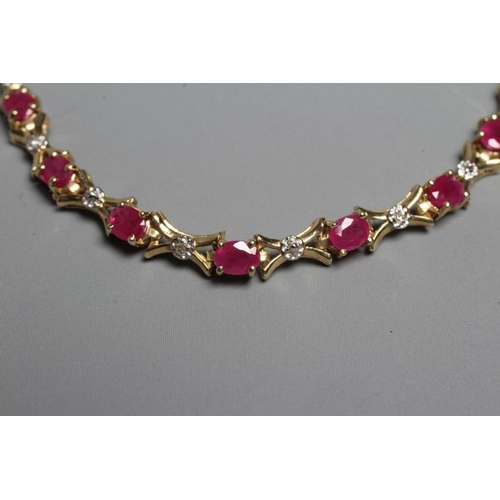 404 - A RUBY AND DIAMOND BRACELET, the sixteen oval facet cut rubies claw set with X links between, and ea... 