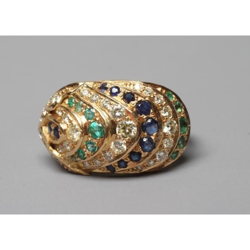 405 - A MULTI-GEM COCKTAIL RING, the oval panelled boss set with rows of diamonds, emeralds and sapphires ... 