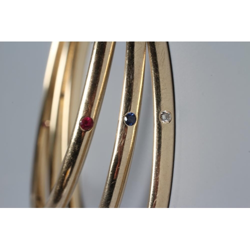 408 - A MATCHED SET OF THREE STONE SET 9CT GOLD BANGLES, set with either eight diamonds, rubies or sapphir... 