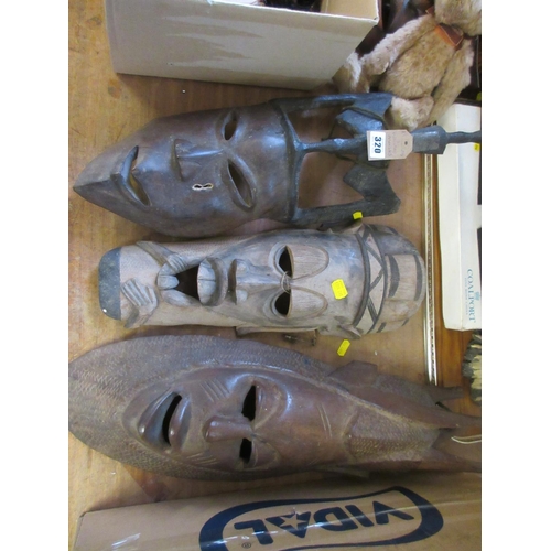 320 - THREE WOODEN AFRICAN MASKS