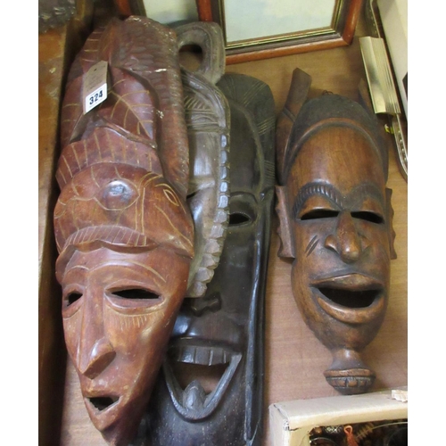 324 - FOUR WOODEN MASKS