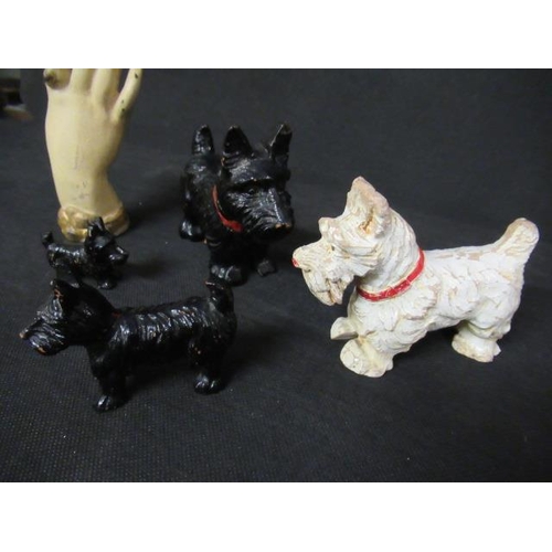 6 - FOUR PAINTED WOOD SCOTTY DOGS AND A METAL HAND PAPERWEIGHT