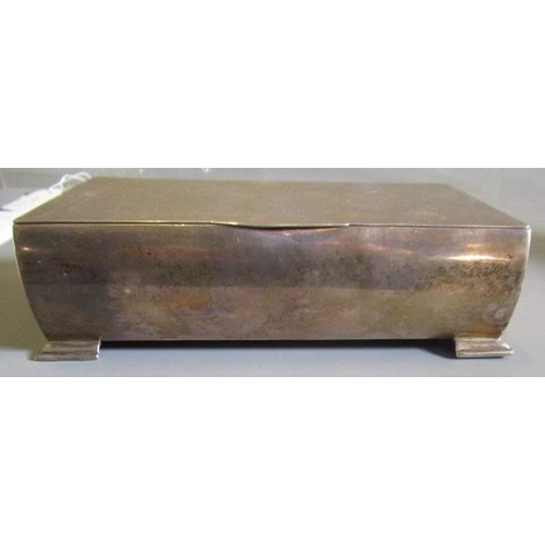 151 - AN ART DECO SILVER CIGARETTE BOX by John Rose, Birmingham 1938, of bombe oblong form raised upon fou... 