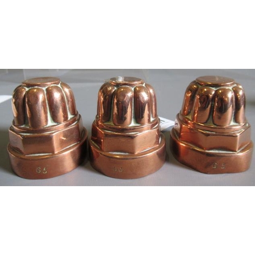 411 - TWO SETS OF THREE SMALL VICTORIAN COPPER JELLY MOULDS of fluted tapering cylindrical form, one set s... 