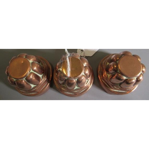 411 - TWO SETS OF THREE SMALL VICTORIAN COPPER JELLY MOULDS of fluted tapering cylindrical form, one set s... 